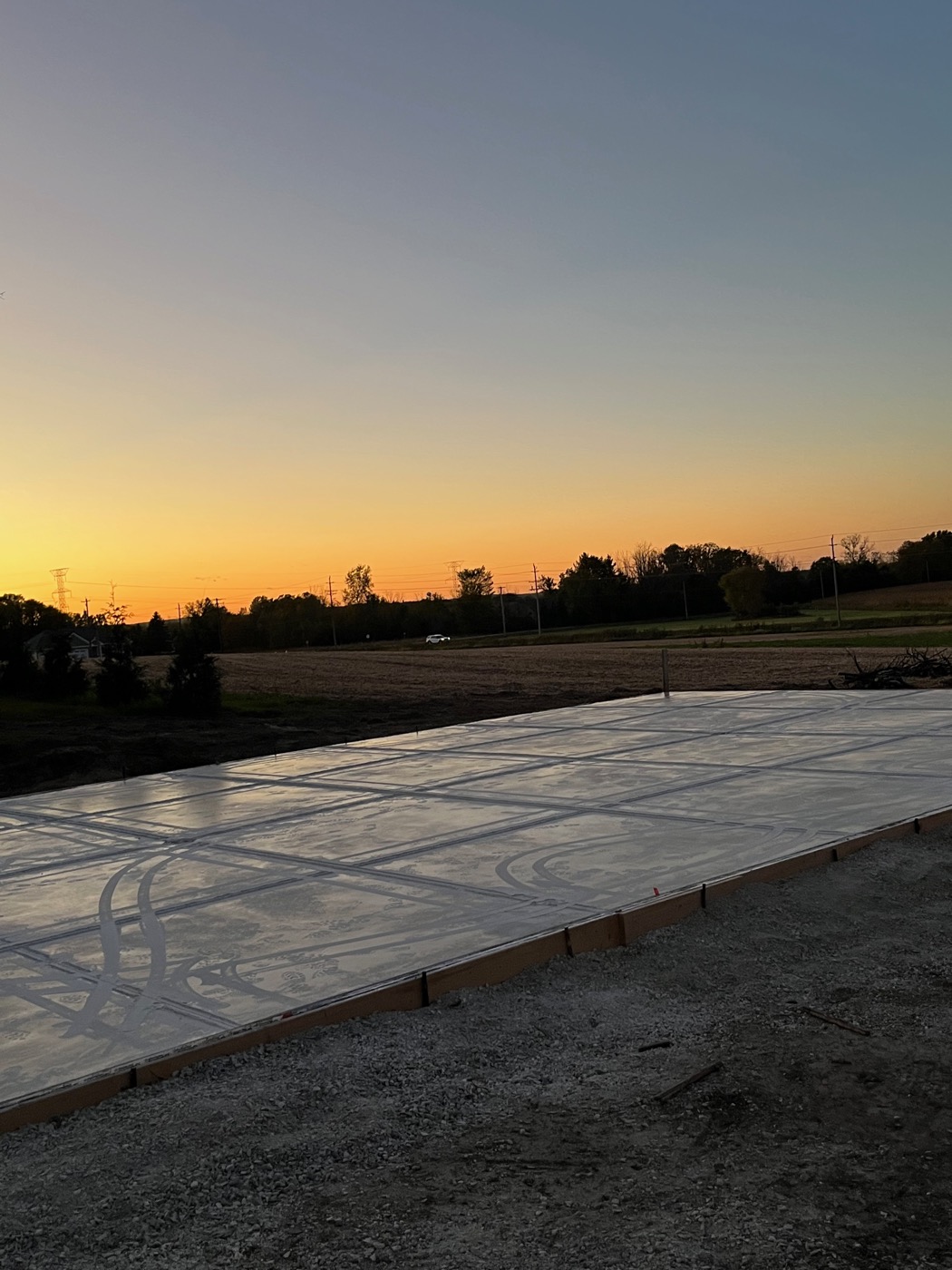 Large concrete driveway pour at sunset, Wisconsin