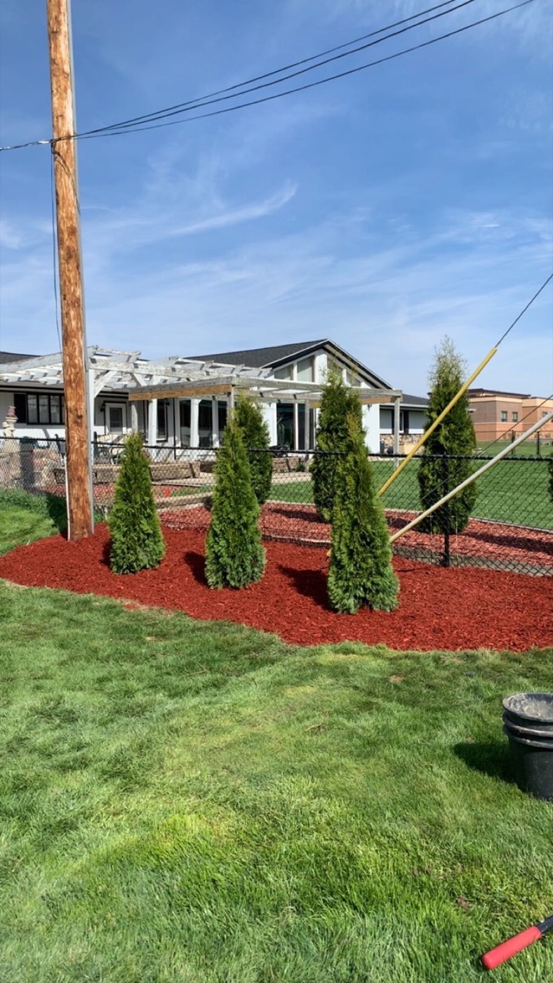 Red mulch installation around landscape beds in Wisconsin