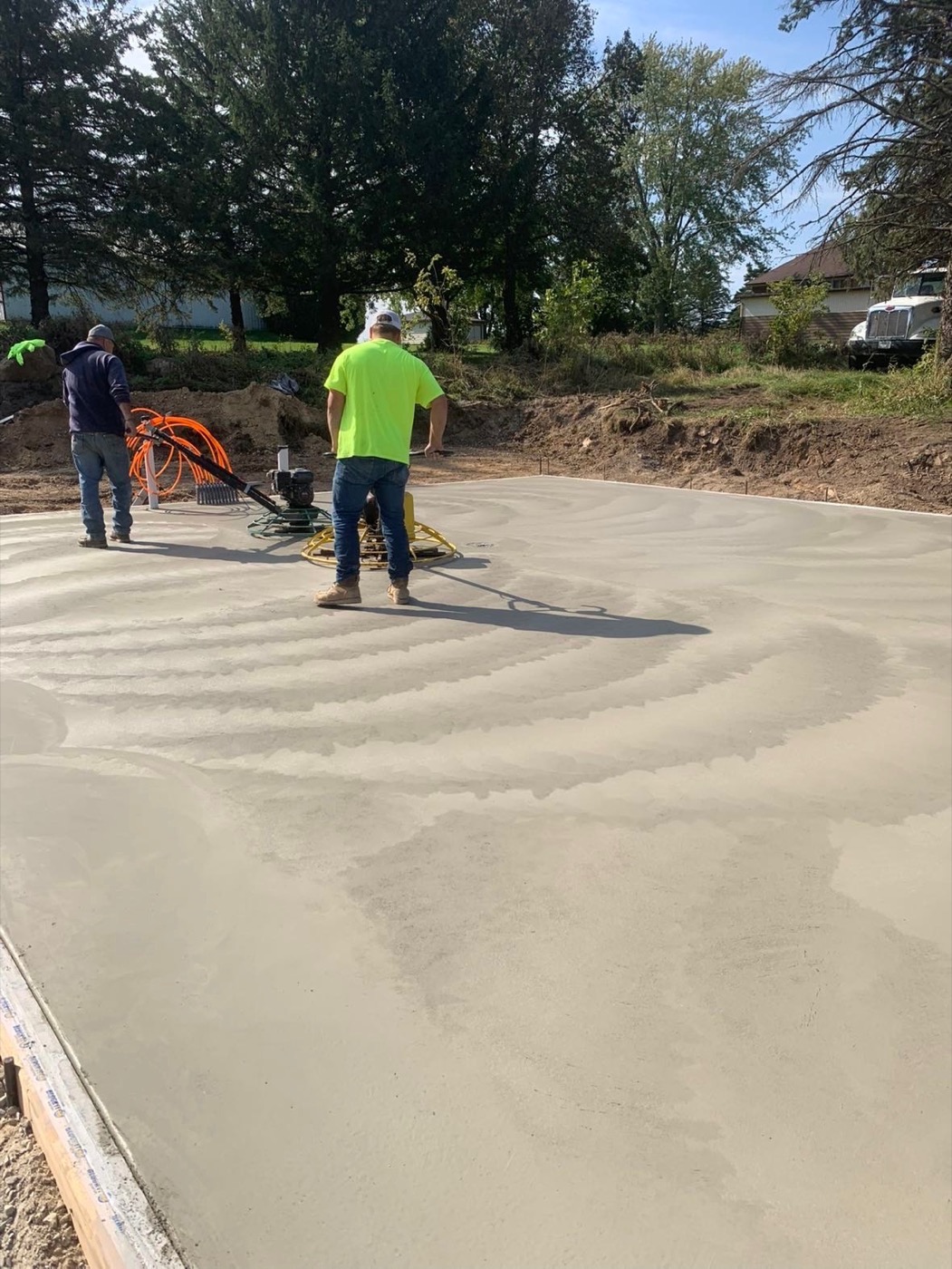 Mozdzen Landscaping crew finishing concrete surface, WI